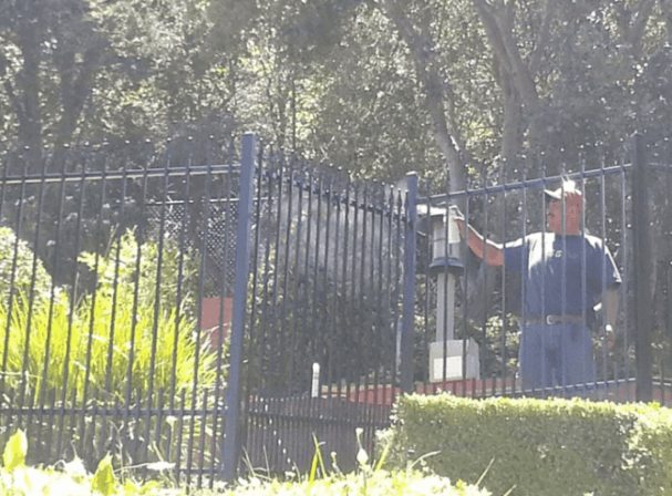 a person painting fence