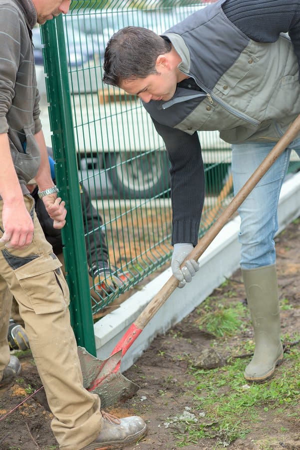 two worker working near fences