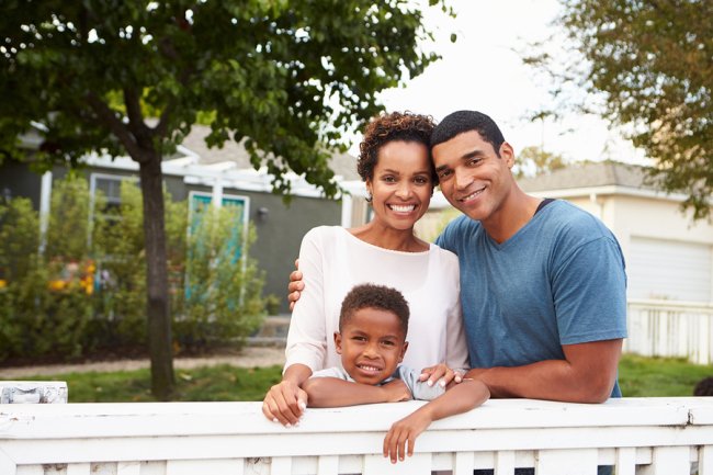 a couple with a child smiling