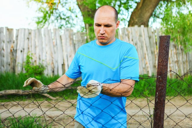 a man fixing fences